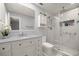Bright bathroom with a walk-in shower, vanity, and decorative flower arrangement at 2201 Ne 45Th St, Ocala, FL 34479