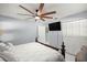 Cozy bedroom featuring a ceiling fan, television, and closet space at 2201 Ne 45Th St, Ocala, FL 34479