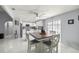 Open dining area featuring white marble floors, a modern ceiling fan, and views into the kitchen at 2201 Ne 45Th St, Ocala, FL 34479