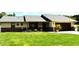 Charming single-story home with a well-maintained lawn, garden, and two-car garage at 2201 Ne 45Th St, Ocala, FL 34479