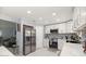 Modern kitchen with stainless steel appliances, white marble floors, and mosaic backsplash at 2201 Ne 45Th St, Ocala, FL 34479