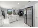 Bright, open kitchen featuring stainless steel appliances, white marble floors, and quartz countertops at 2201 Ne 45Th St, Ocala, FL 34479