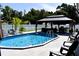 Backyard pool area featuring a pool, outdoor seating, and privacy fence at 2201 Ne 45Th St, Ocala, FL 34479