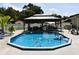Inviting backyard pool area with an octagonal pool and gazebo, creating a relaxing outdoor oasis at 2201 Ne 45Th St, Ocala, FL 34479