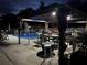A covered gazebo and in-ground swimming pool that's lit up at night for a relaxing vibe and nighttime fun at 2201 Ne 45Th St, Ocala, FL 34479