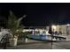 Inviting in-ground pool with underwater lights, complemented by a covered gazebo and lush landscaping, perfect for evening relaxation at 2201 Ne 45Th St, Ocala, FL 34479
