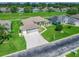 Aerial perspective of a property on a golf course, boasting a three-car garage and landscaped surroundings at 2478 Nw 53Rd Avenue Rd, Ocala, FL 34482