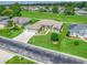 Aerial view of a home with manicured lawns, a wide driveway, and situated on a picturesque golf course at 2478 Nw 53Rd Avenue Rd, Ocala, FL 34482