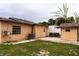View of home's backyard with grass area, patio seating, and a shed at 2563 Coral Ave, Kissimmee, FL 34741