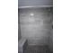 Gray tiled shower with built-in bench seating and dark mosaic tile floor at 2563 Coral Ave, Kissimmee, FL 34741