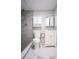 Modern bathroom with gray tile shower, rainfall showerhead, and white marble floors at 2563 Coral Ave, Kissimmee, FL 34741