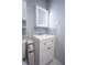Bathroom vanity with white cabinets, nickel hardware, and lighted mirror at 2563 Coral Ave, Kissimmee, FL 34741