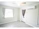 Comfortable bedroom featuring tile flooring, a ceiling fan, an AC unit, and natural light at 2563 Coral Ave, Kissimmee, FL 34741