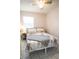 Bright bedroom featuring tile floor, patterned bedding, and a bedside table at 2563 Coral Ave, Kissimmee, FL 34741