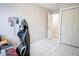 An additional bedroom with a desk, white tiled floors and a closet at 2563 Coral Ave, Kissimmee, FL 34741