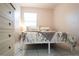Bright bedroom showcasing patterned bedding, a throw blanket, and a white dresser at 2563 Coral Ave, Kissimmee, FL 34741