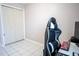 Bedroom featuring tiled floors, desk, and a closet for ample storage space at 2563 Coral Ave, Kissimmee, FL 34741