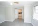 Charming bedroom with tile floors, light walls, and a glimpse into the kitchen at 2563 Coral Ave, Kissimmee, FL 34741