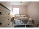 Bright bedroom with marble patterned bedding, throw blanket, and white dresser at 2563 Coral Ave, Kissimmee, FL 34741