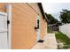 Exterior side view of the home with a private entrance and fenced yard at 2563 Coral Ave, Kissimmee, FL 34741