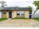 Charming single-story home with stone accents, a well-maintained front yard, and a concrete driveway at 2563 Coral Ave, Kissimmee, FL 34741