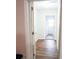 Hallway featuring wood flooring and a laundry room in the background at 2563 Coral Ave, Kissimmee, FL 34741