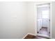 Hallway showcasing wood flooring, leading to a laundry room with a washer and dryer at 2563 Coral Ave, Kissimmee, FL 34741