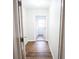 Hallway featuring wood flooring and a laundry room in the background at 2563 Coral Ave, Kissimmee, FL 34741