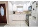 Well-lit kitchen with white cabinets, stainless steel appliances, and mosaic backsplash at 2563 Coral Ave, Kissimmee, FL 34741
