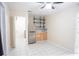 Kitchenette with shelving and stainless steel refrigerator at 2563 Coral Ave, Kissimmee, FL 34741