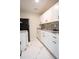 Bright kitchen features white cabinets, black hardware, and stone countertops at 2563 Coral Ave, Kissimmee, FL 34741