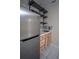 This kitchenette has a stainless steel fridge, light wood cabinets, marble counter and backsplash, and floating shelving at 2563 Coral Ave, Kissimmee, FL 34741