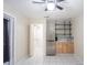 Open layout with kitchenette, stainless steel fridge, and an open closet with storage at 2563 Coral Ave, Kissimmee, FL 34741