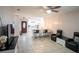 Spacious open-plan living room flows into the kitchen, featuring sleek tile floors at 2563 Coral Ave, Kissimmee, FL 34741