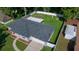This aerial view showcases the home, a well-kept lawn, a fenced backyard, and a detached garage at 26 Hemlock Terrace Dr, Ocala, FL 34472