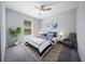 Staged bedroom features a cozy bed, stylish decor, carpet, and a window at 26 Hemlock Terrace Dr, Ocala, FL 34472