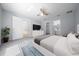Bright bedroom featuring a ceiling fan, carpeting, TV, and ensuite bathroom access at 26 Hemlock Terrace Dr, Ocala, FL 34472