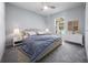 Cozy bedroom features a ceiling fan, neutral decor and a large window for natural light at 26 Hemlock Terrace Dr, Ocala, FL 34472