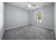 Neutral bedroom with carpet flooring, a window, and a ceiling fan at 26 Hemlock Terrace Dr, Ocala, FL 34472