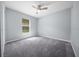 Neutral bedroom with carpet, a ceiling fan, and a window providing natural light at 26 Hemlock Terrace Dr, Ocala, FL 34472