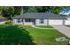 Charming single-story home with a well-manicured lawn, blue shutters, and an attached garage at 26 Hemlock Terrace Dr, Ocala, FL 34472