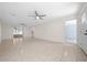 Bright living room featuring tile flooring, ceiling fans, and access to a sliding glass door leading to the outdoors at 26 Hemlock Terrace Dr, Ocala, FL 34472