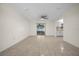 Bright living room with tile flooring, a ceiling fan, and sliding glass doors leading to the backyard at 26 Hemlock Terrace Dr, Ocala, FL 34472