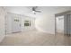 Bright living room with tile flooring, a window for natural light, and a doorway leading to the bathroom at 26 Hemlock Terrace Dr, Ocala, FL 34472