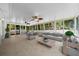 Large staged screened-in back porch, ceiling fans, tile floor, and windows that bring in natural light at 26 Hemlock Terrace Dr, Ocala, FL 34472