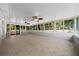 Large screened-in back porch, ceiling fans, tile floor, and windows that bring in natural light at 26 Hemlock Terrace Dr, Ocala, FL 34472