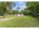 Exterior view of the home showing the large, well-maintained lawn and driveway at 2602 Ne 2Nd Ave, Ocala, FL 34470