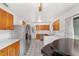 Eat-in kitchen with stainless steel appliances, wood cabinets, breakfast table and chairs, and tile floor at 2602 Ne 2Nd Ave, Ocala, FL 34470