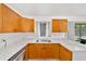 Well-lit kitchen features marble countertops, wooden cabinetry, and stainless steel appliances at 2602 Ne 2Nd Ave, Ocala, FL 34470