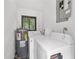 This functional laundry area features a window, washer, dryer, and water heater at 2602 Ne 2Nd Ave, Ocala, FL 34470